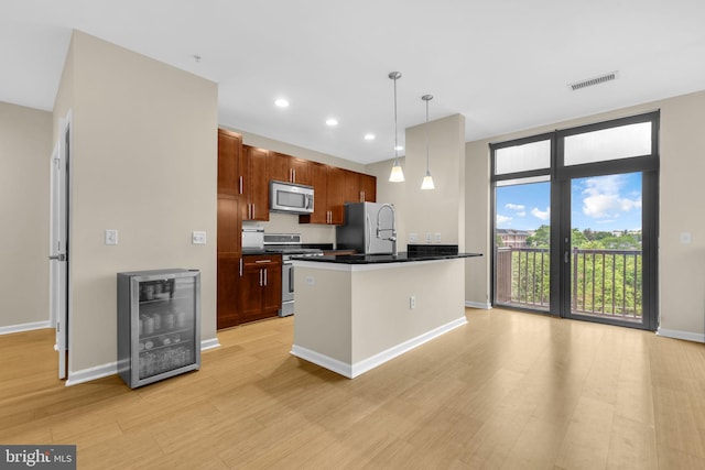 444 W Broad St Unit 407, Falls Church, VA 22046 - kitchen with stainless steel appliances, beverage cooler, dark countertops, light wood-type flooring, and baseboards