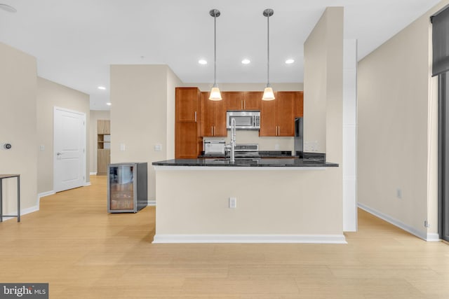 444 W Broad St Unit 407, Falls Church, VA 22046 - kitchen featuring stainless steel appliances, wine cooler, brown cabinetry, baseboards, and recessed lighting