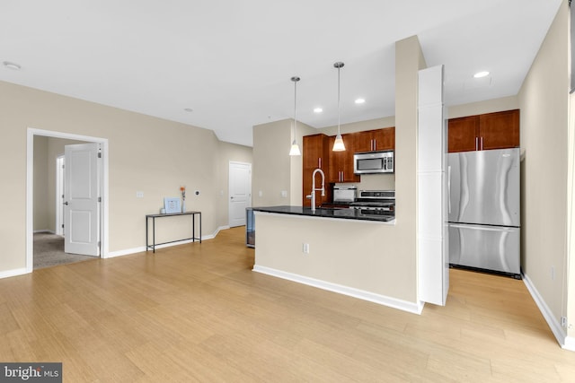 444 W Broad St Unit 407, Falls Church, VA 22046 - kitchen with stainless steel appliances, light wood-style floors, pendant lighting, dark countertops, and recessed lighting