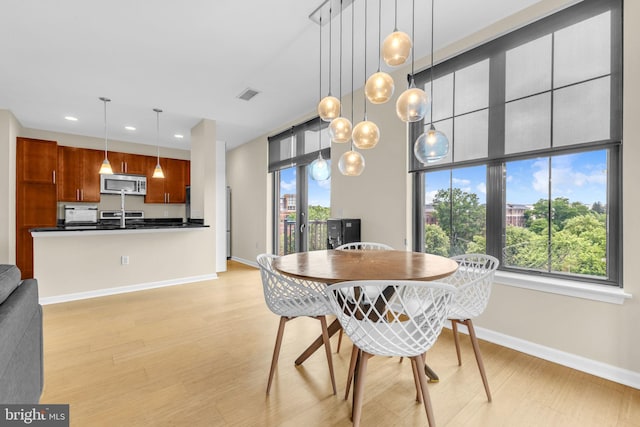 444 W Broad St Unit 407, Falls Church, VA 22046 - dining area featuring recessed lighting, light wood finished floors, and baseboards