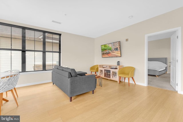 444 W Broad St Unit 407, Falls Church, VA 22046 - living area with light wood-style flooring and baseboards