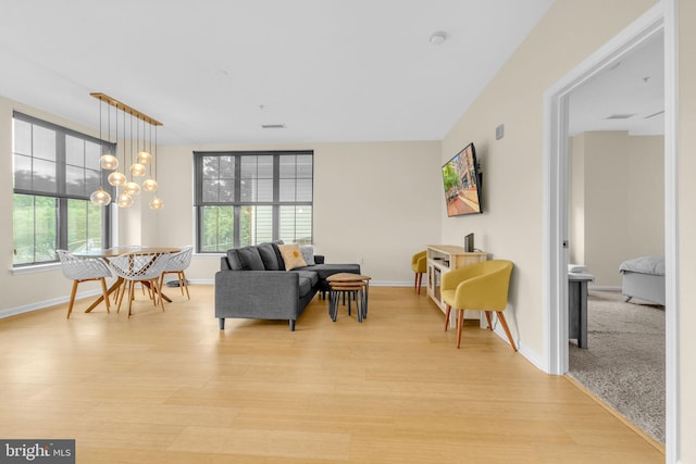 444 W Broad St Unit 407, Falls Church, VA 22046 - living area with healthy amount of natural light, light wood-type flooring, and baseboards