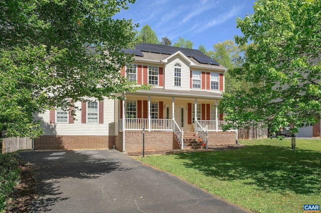 2364 N Chesterfield Ct, Charlottesville, VA 22911 - colonial inspired home featuring covered porch, a front yard, roof mounted solar panels, and asphalt driveway