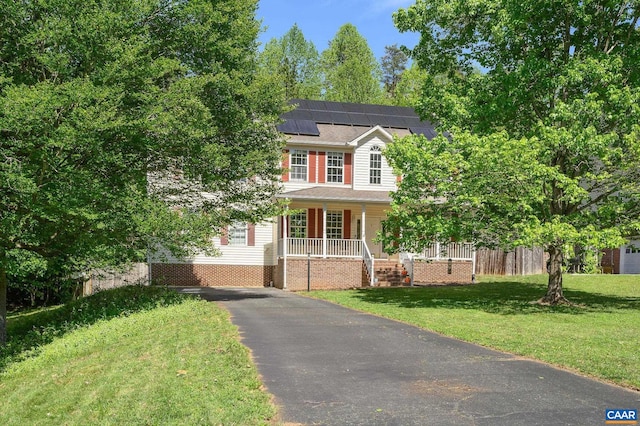 2364 N Chesterfield Ct, Charlottesville, VA 22911 - colonial house featuring covered porch, driveway, solar panels, and a front lawn