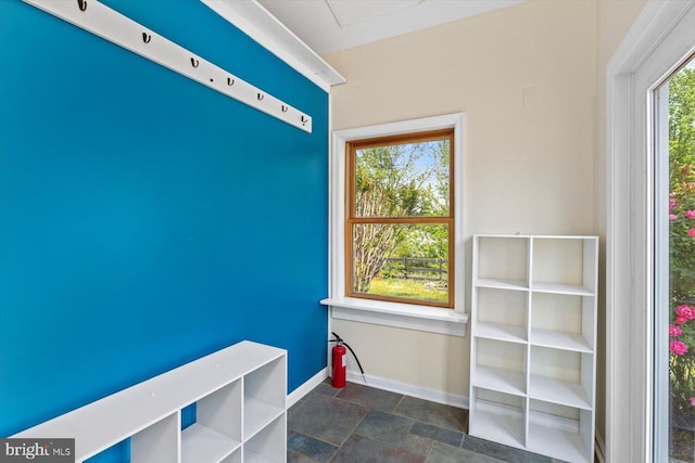 interior space with baseboards and stone finish flooring