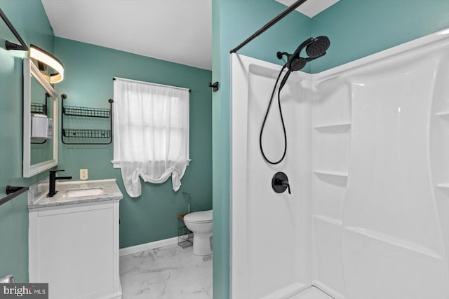 bathroom with vanity, marble finish floor, a shower, and toilet