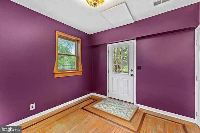 entrance foyer featuring visible vents, baseboards, and hardwood / wood-style flooring