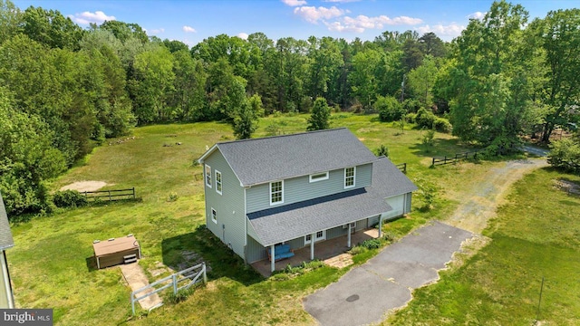 birds eye view of property featuring a wooded view