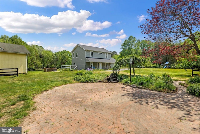 back of property featuring a lawn