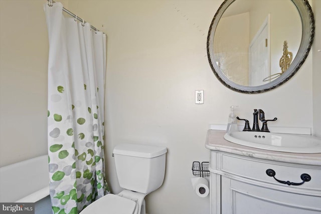 bathroom featuring vanity and toilet