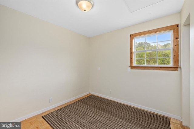 spare room featuring baseboards