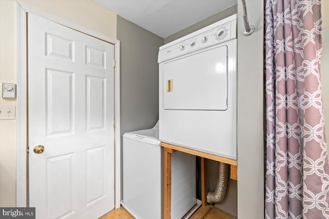 washroom with laundry area and stacked washer / dryer