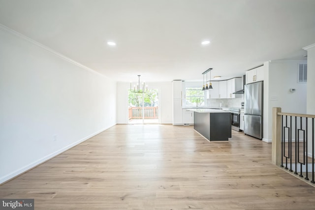 1797 Valleyside Dr, Frederick, MD 21702 - unfurnished living room featuring crown molding, a chandelier, recessed lighting, baseboards, and light wood-style floors