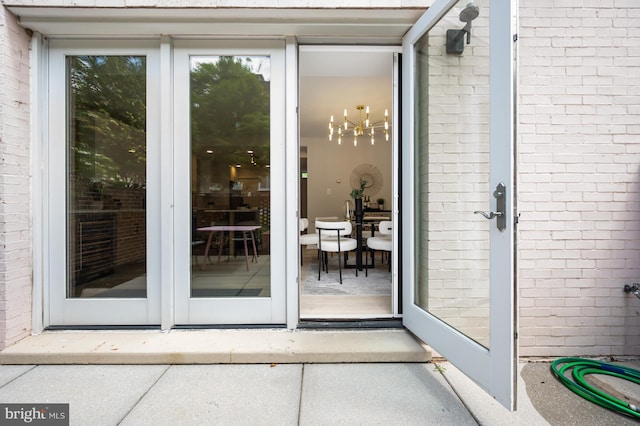 property entrance featuring brick siding
