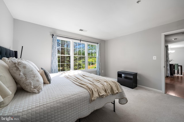 bedroom with visible vents, carpet flooring, and baseboards