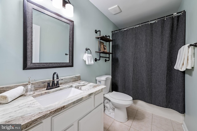 bathroom with vanity, tile patterned floors, and toilet