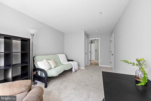 sitting room with carpet floors and baseboards