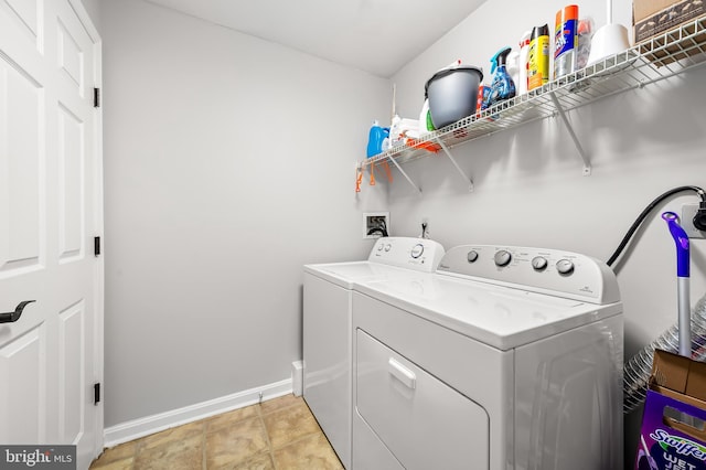 laundry room featuring baseboards, laundry area, and independent washer and dryer