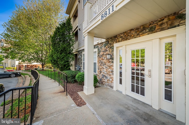 property entrance featuring stone siding