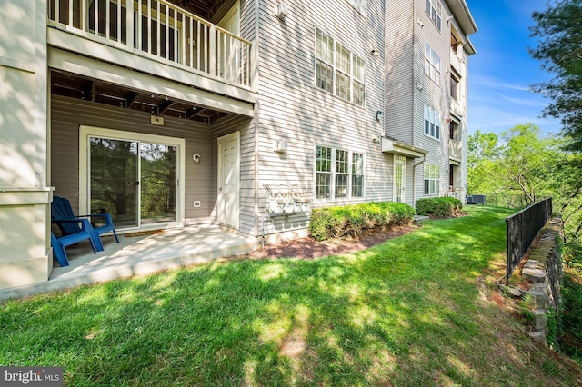 exterior space featuring a yard, cooling unit, and a balcony