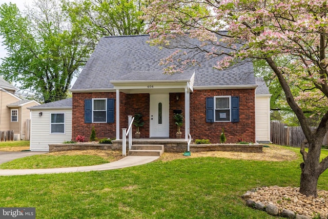 404 Crescent Rd, Hatboro, PA 19040 - view of front of property with covered porch, fence, brick siding, a front yard, and a shingled roof