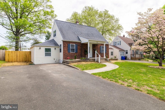 404 Crescent Rd, Hatboro, PA 19040 - view of front of home featuring roof with shingles, fence, brick siding, a front lawn, and a chimney