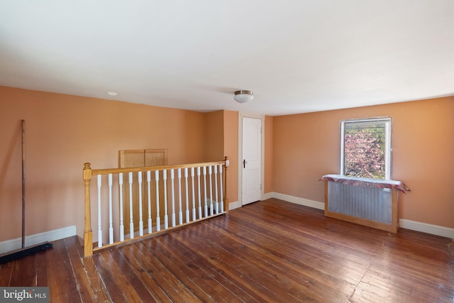 unfurnished room featuring baseboards and hardwood / wood-style flooring