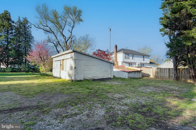 view of yard with fence and an outdoor structure