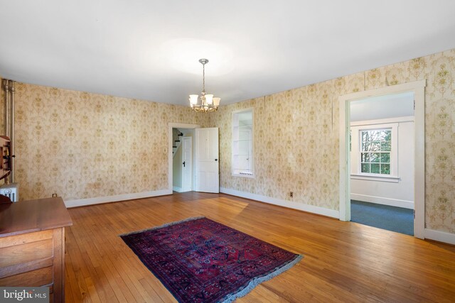 2200 Enterprise Rd, Bowie, MD 20721 - unfurnished dining area featuring an inviting chandelier, baseboards, hardwood / wood-style floors, and wallpapered walls