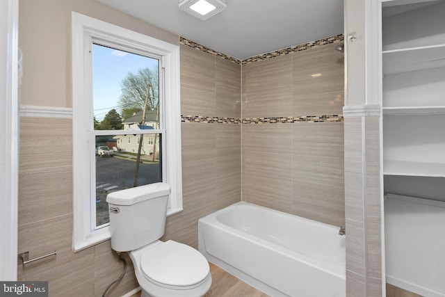 bathroom featuring shower / bathing tub combination and toilet