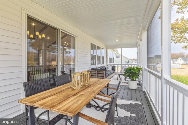 sunroom / solarium featuring outdoor dining space