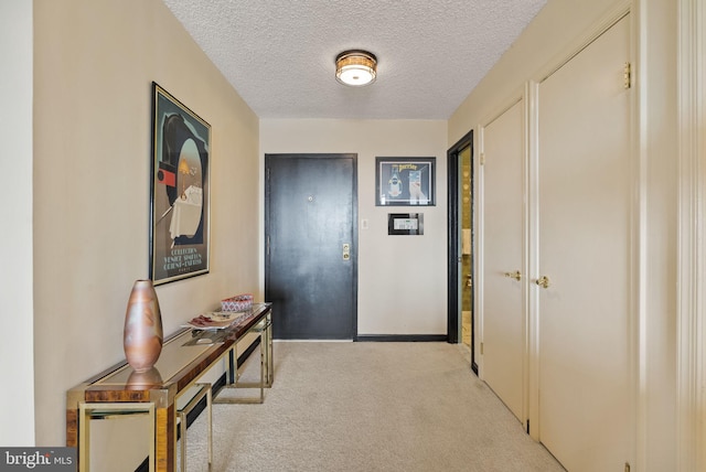 1101 S Arlington Ridge Rd Unit 1107, Arlington, VA 22202 - corridor with light colored carpet, a textured ceiling, and baseboards