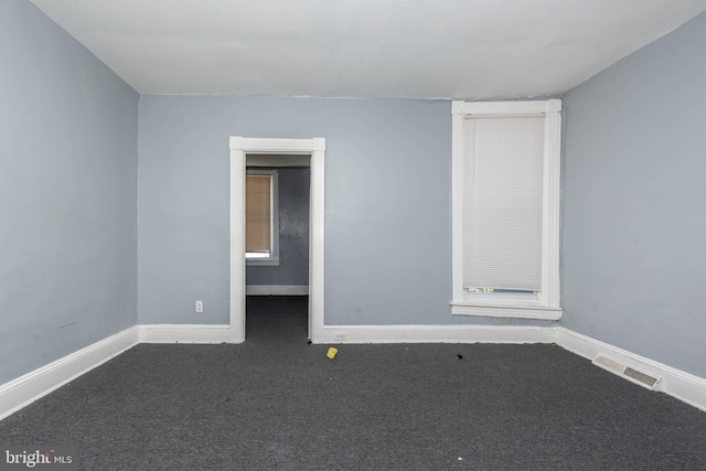 unfurnished room featuring carpet floors, baseboards, and visible vents