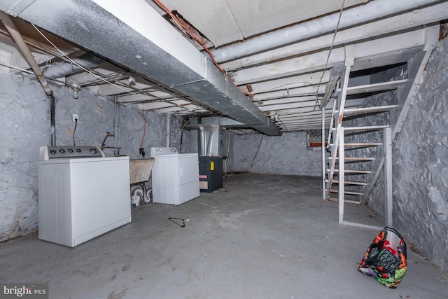 unfinished below grade area with washing machine and clothes dryer