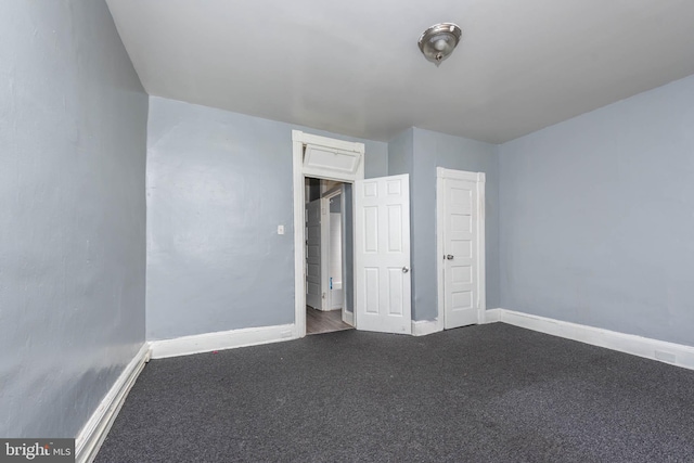 unfurnished bedroom with carpet flooring and baseboards