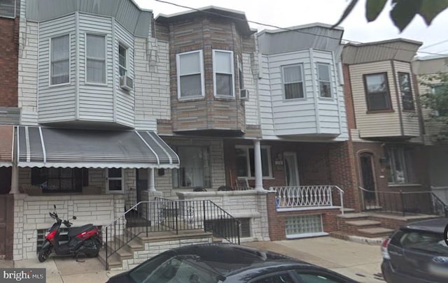 view of property featuring covered porch