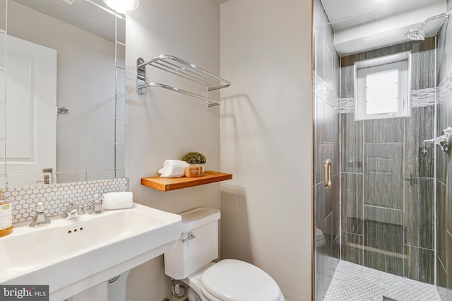 418 Seward Sq SE Unit 3, Washington, DC 20003 - full bathroom featuring toilet, a shower stall, a sink, and decorative backsplash
