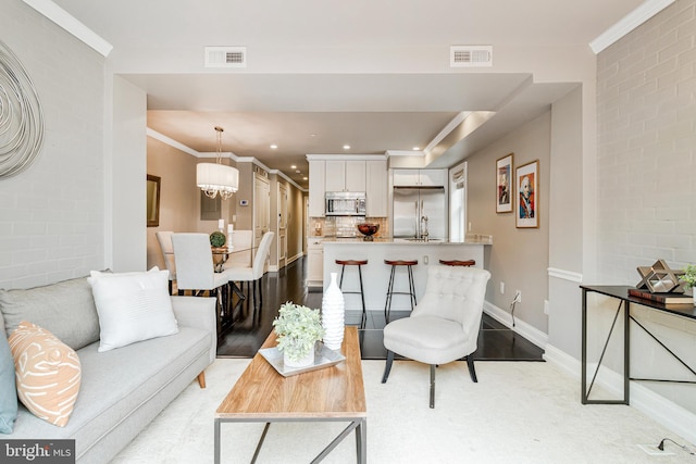 418 Seward Sq SE Unit 3, Washington, DC 20003 - living area with recessed lighting, baseboards, a chandelier, and crown molding