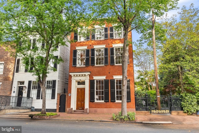 304 S Saint Asaph St, Alexandria, VA 22314 - view of front facade featuring brick siding, a gate, and fence