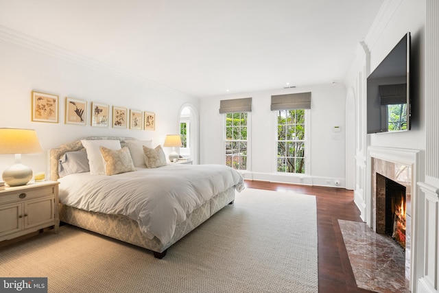 304 S Saint Asaph St, Alexandria, VA 22314 - bedroom with wood finished floors, a fireplace, multiple windows, ornamental molding, and recessed lighting