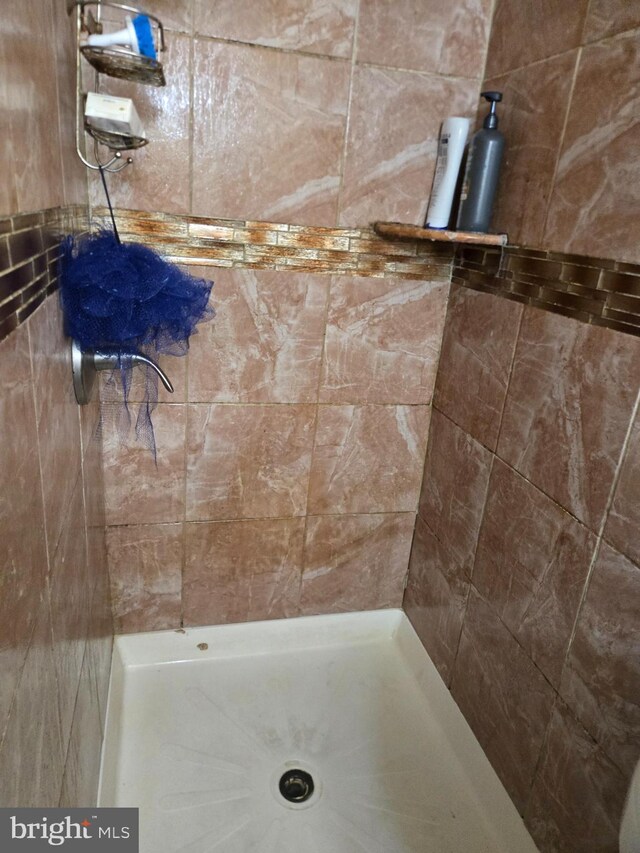full bath featuring tiled shower