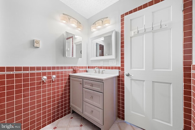 54 Dogwood Rd, Manahawkin, NJ 08050 - bathroom with tile walls, vanity, a textured ceiling, tile patterned flooring, and wainscoting