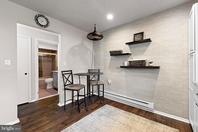 54 Dogwood Rd, Manahawkin, NJ 08050 - dining room featuring a textured ceiling, baseboards, baseboard heating, and wood finished floors