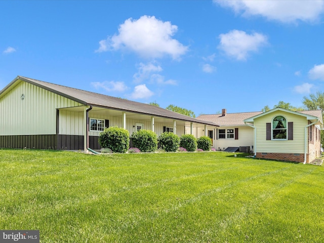 9203 Oak Tree Cir, Frederick, MD 21701 - back of house with board and batten siding, a lawn, and central air condition unit