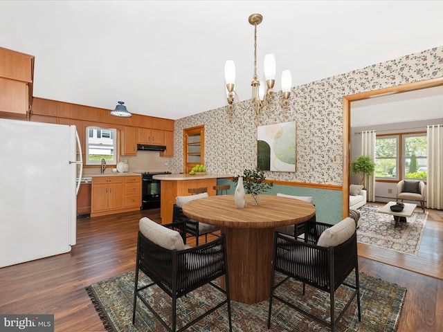 9203 Oak Tree Cir, Frederick, MD 21701 - dining room featuring a healthy amount of sunlight, dark wood-style flooring, wallpapered walls, and a chandelier