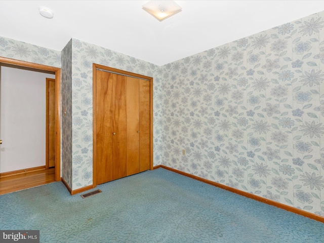 9203 Oak Tree Cir, Frederick, MD 21701 - unfurnished bedroom featuring visible vents, carpet floors, baseboards, a closet, and wallpapered walls
