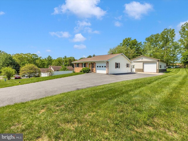 9203 Oak Tree Cir, Frederick, MD 21701 - view of front facade with a garage, an outdoor structure, a front lawn, and brick siding