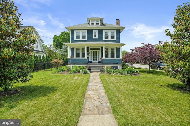 american foursquare style home with a chimney and a porch