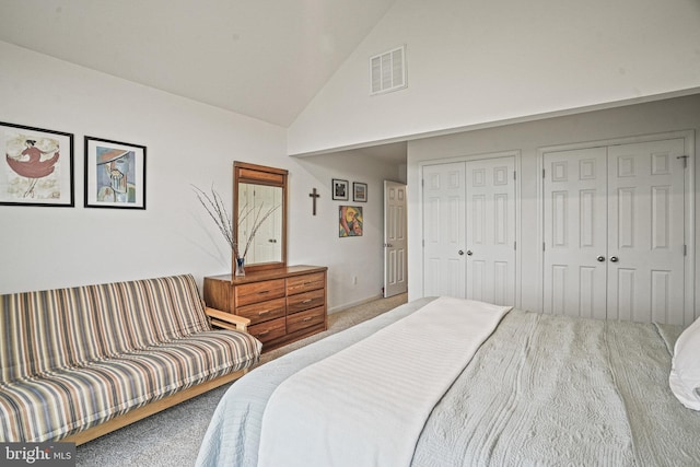 bedroom with two closets, carpet flooring, high vaulted ceiling, and visible vents