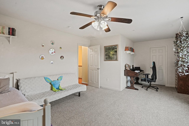 interior space with carpet floors, a ceiling fan, and baseboards